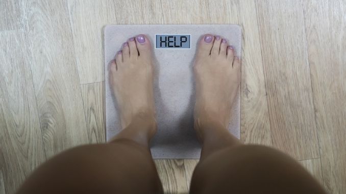 standing on scale - Boosting Your Metabolism
