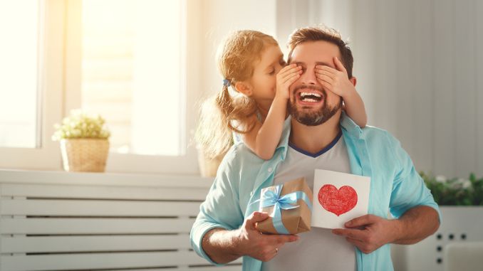 daughter-hugging-dad-laughs - Father's Day Traditions