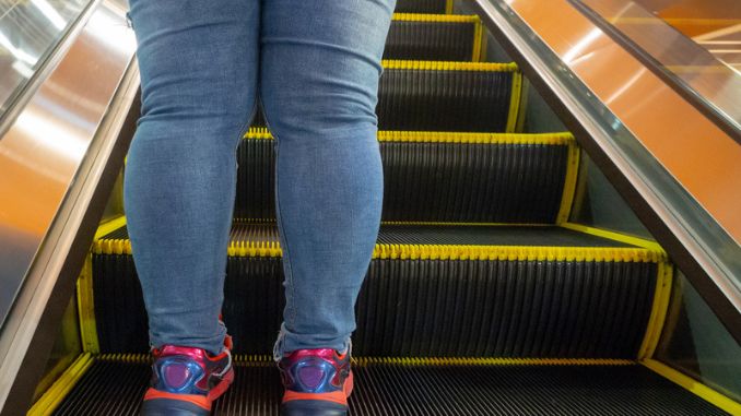 Women leg standing escalator